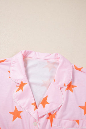 Pink pajama set with orange stars, button front, and piped collar detail.