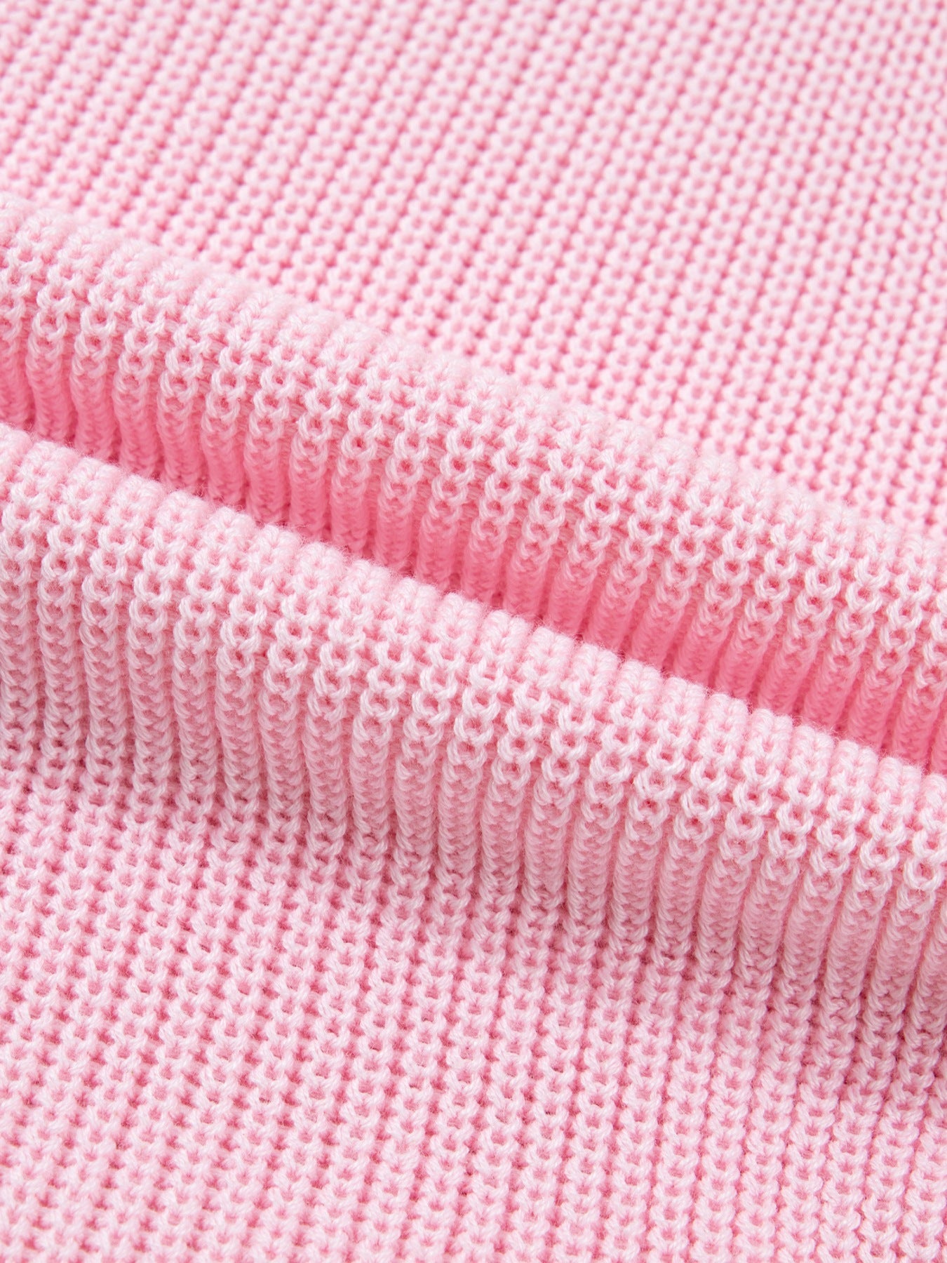 Pink acrylic knit sweater vest with V-neck and button front detail.
