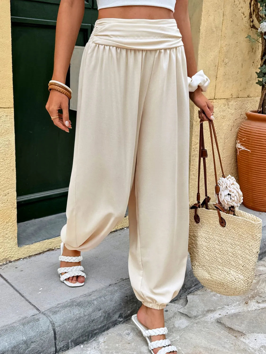 Cream ruched waistline balloon trousers with elastic cuffs and a relaxed fit.