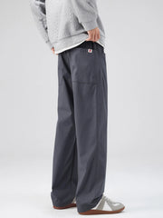 Dark gray casual loose fit pants with patch pockets and a red U logo detail.