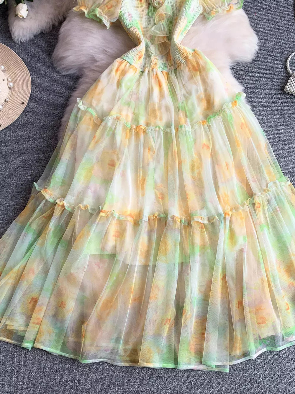 Floral tiered midi dress in sherbet with smocked bodice and sheer overlay.