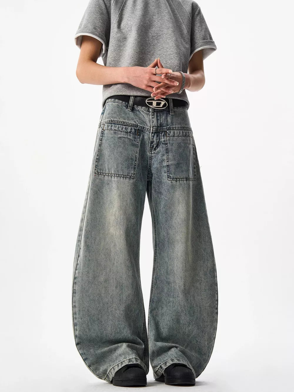 Belted wide-leg blue denim jeans with a baggy fit and contemporary style.