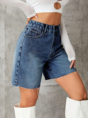 High-waisted denim bermuda shorts in medium blue wash with frayed hem.