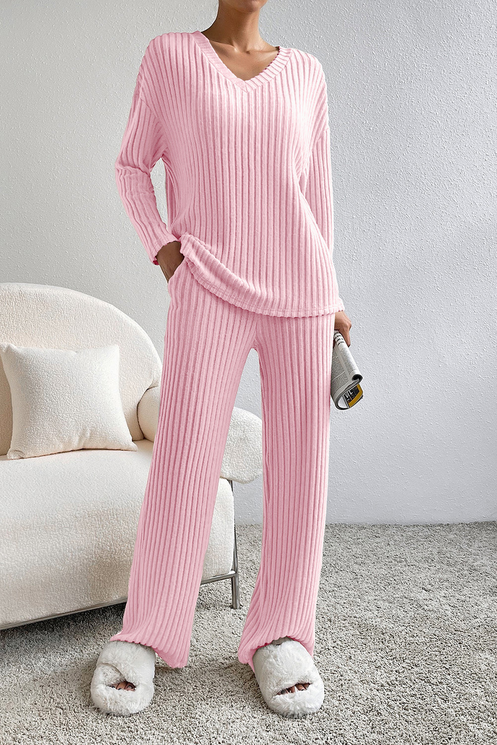 Pink ribbed knit lounge set with V-neck top and wide-leg pants.