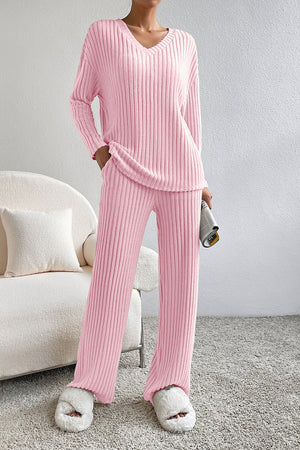 Pink ribbed knit lounge set with V-neck top and wide-leg pants.