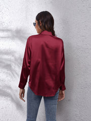 Burgundy silken button-down shirt with a relaxed fit and classic collar.