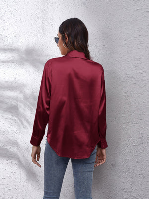 Burgundy silken button-down shirt with a relaxed fit and classic collar.