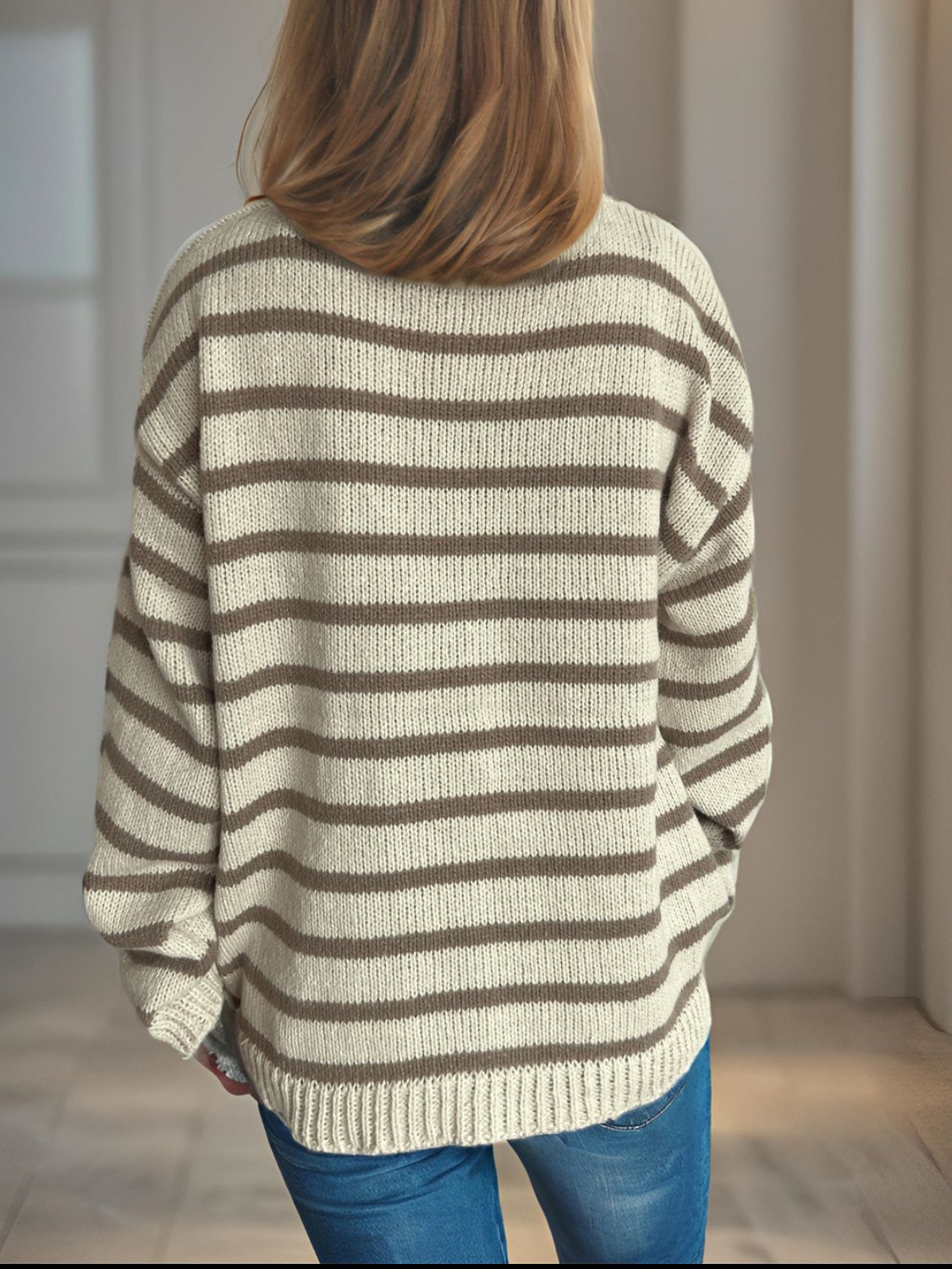 Breton stripe relaxed knit sweater in tan and white acrylic with a crew neck and long sleeves.