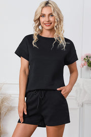 Black geometric quilted tee and shorts set with drawstring waist.