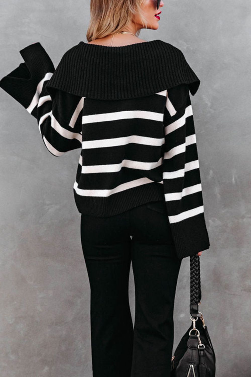 Black and white striped knit sweater with wide collar and bell sleeves.