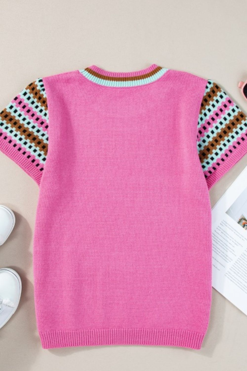Geometric sleeve knit top in fuchsia pink with striped neckline and patterned short sleeves.