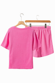 Fuchsia pink waffle knit loungewear set with a short sleeve top and elastic waist shorts.