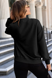 Black bomber jacket with diamond quilted texture and ribbed cuffs and hem.