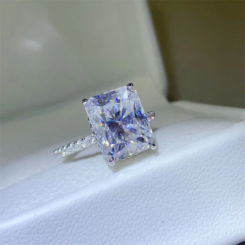 Radiant cut moissanite ring with pavé band in silver.