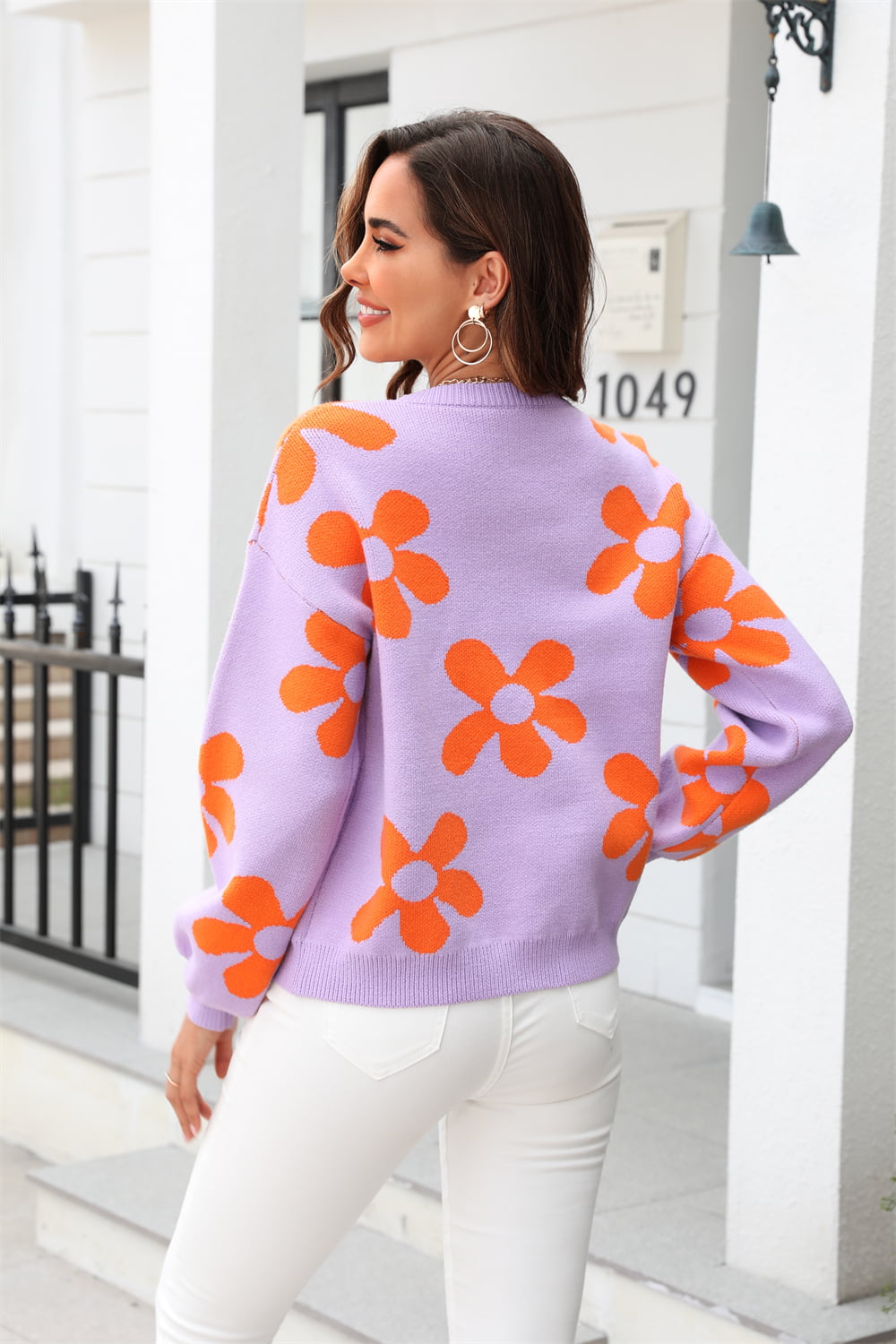 Lavender acrylic sweater with orange floral intarsia pattern, crew neck, long sleeves.
