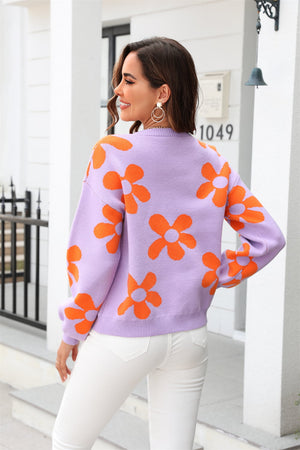 Lavender acrylic sweater with orange floral intarsia pattern, crew neck, long sleeves.