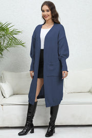 Dark blue oversized knit cardigan with pockets and long sleeves.
