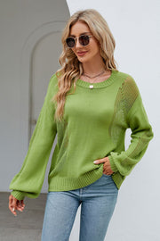 Green knit sweater with crewneck, long sleeves, and slit detail on sides and sleeves.