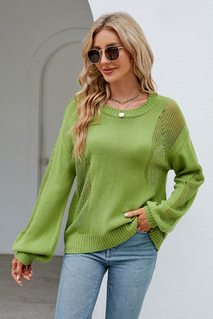Green knit sweater with crewneck, long sleeves, and slit detail on sides and sleeves.