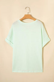 Light green waffle knit t-shirt with cuffed short sleeves and a relaxed fit.