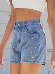 Medium wash denim shorts with allover silver studs and rhinestones.