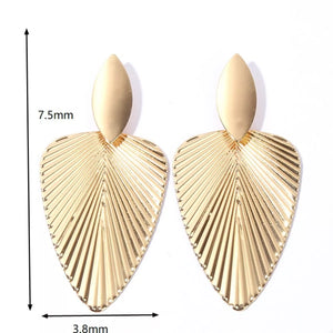 Gold leaf silhouette dangle earrings with textured fan design