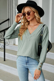 Light green diamond-textured V-neck blouse with button cuffs