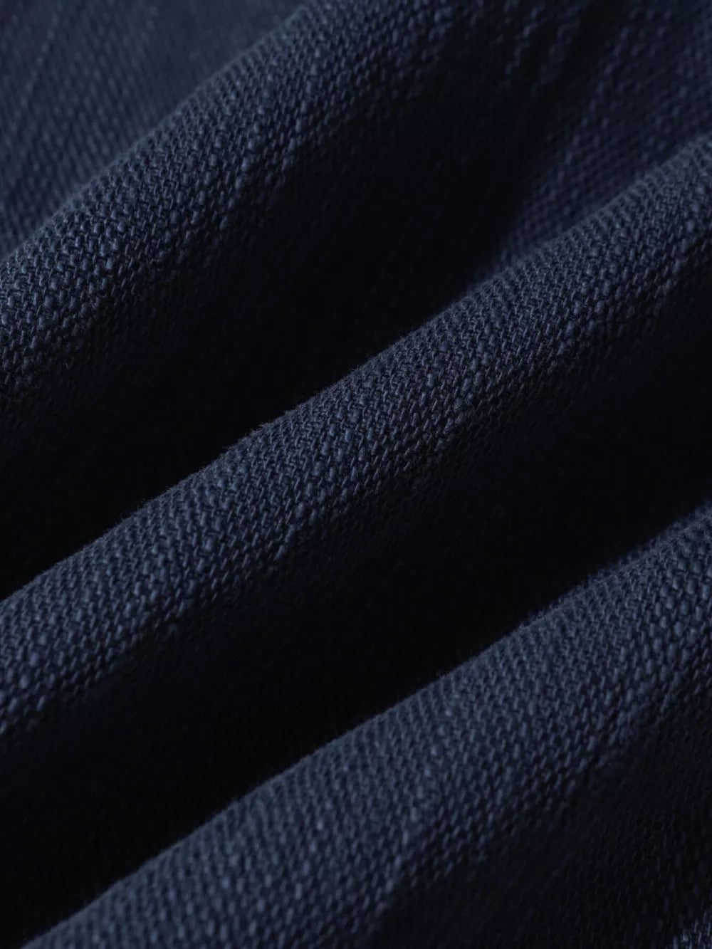 Blue casual cargo pants fabric detail with visible texture and folds.
