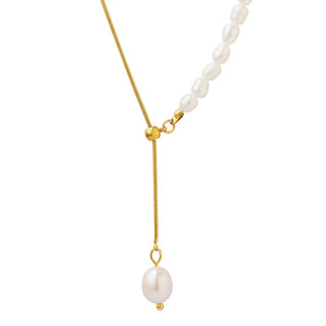 Gold asymmetrical pearl lariat necklace with adjustable length and single pearl drop.