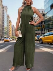 Dark green halter neck wide leg jumpsuit with backless detail.