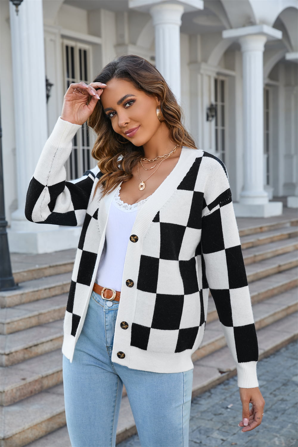 Checkerboard knit v-neck cardigan in black and white acrylic, buttoned front.
