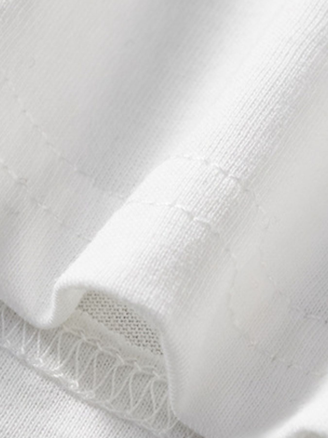 White cotton toddler t-shirt detail showing stitching and fabric texture.