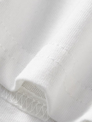 White cotton toddler t-shirt detail showing stitching and fabric texture.