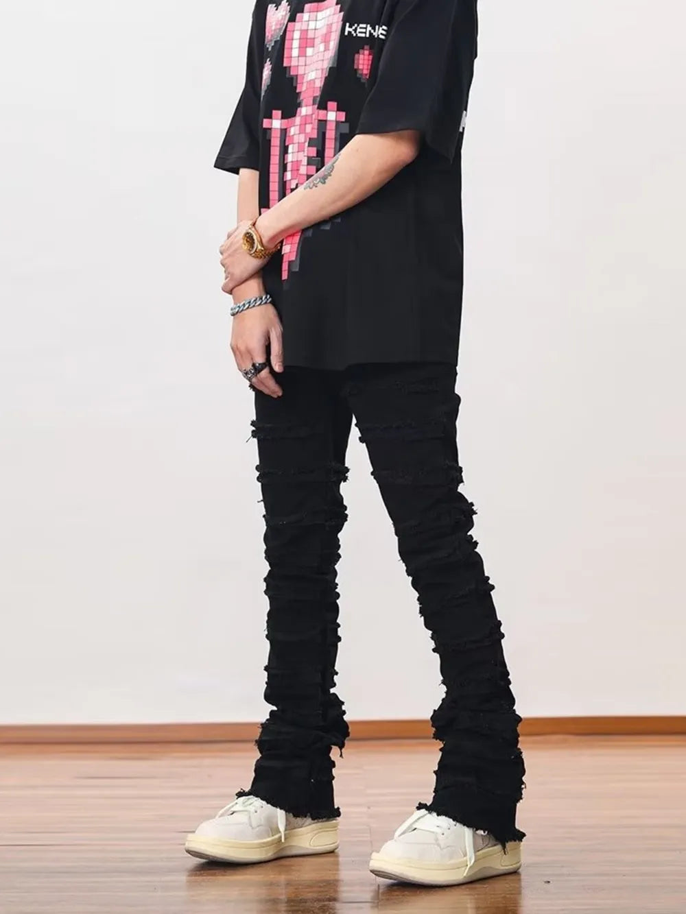 Black cotton jeans for men with frayed hem and stacked detail