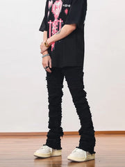 Black cotton jeans for men with frayed hem and stacked detail