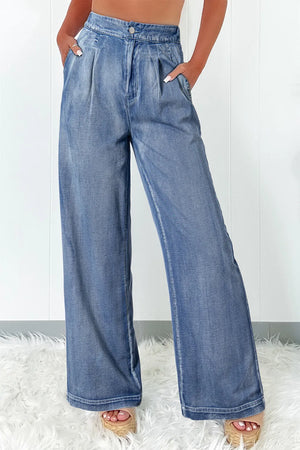 Pleated waist palazzo denim trousers in medium wash, with a wide leg cut.