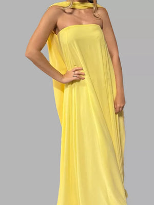 Yellow strapless maxi dress with flowing scarf detail.