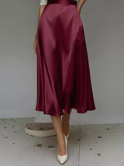 Elegant A-line satin skirt in wine red with pockets, midi length.