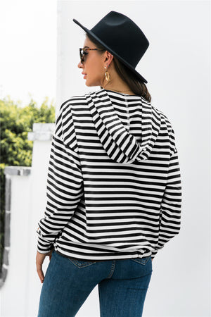 Black and white striped relaxed fit hoodie with drawstring hem and hood.