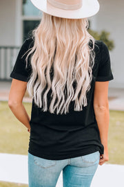 Black graphic t-shirt with rolled sleeves and a crew neck, worn with jeans.