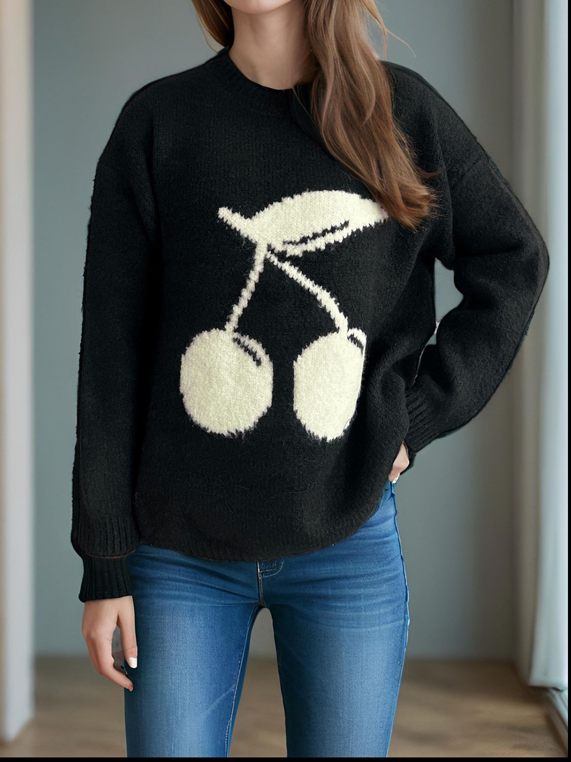 Black acrylic knit sweater with a white cherry motif, crew neck, and long sleeves.