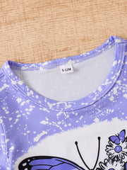 Children's purple butterfly tie-dye t-shirt with white splatters and a size tag.