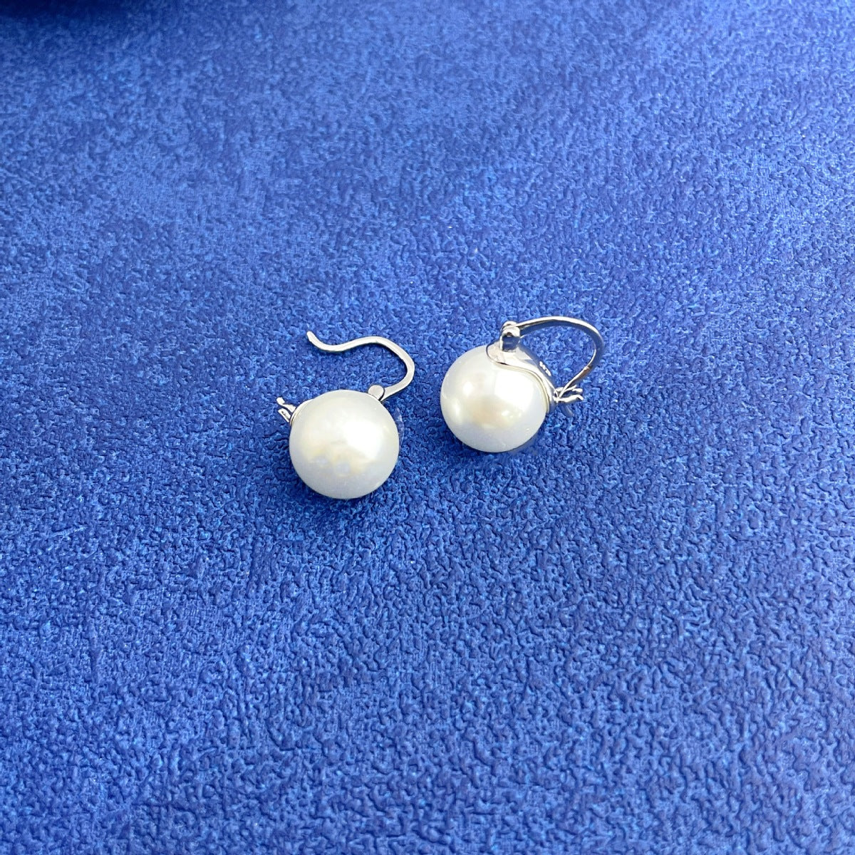 Plated pearl hoop earrings with silver findings and white pearls.