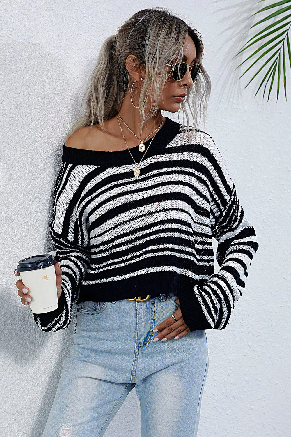Cropped black and white stripe knit crew neck sweater with wide sleeves.