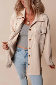 Beige corduroy oversized utility jacket with chest pockets and button front.