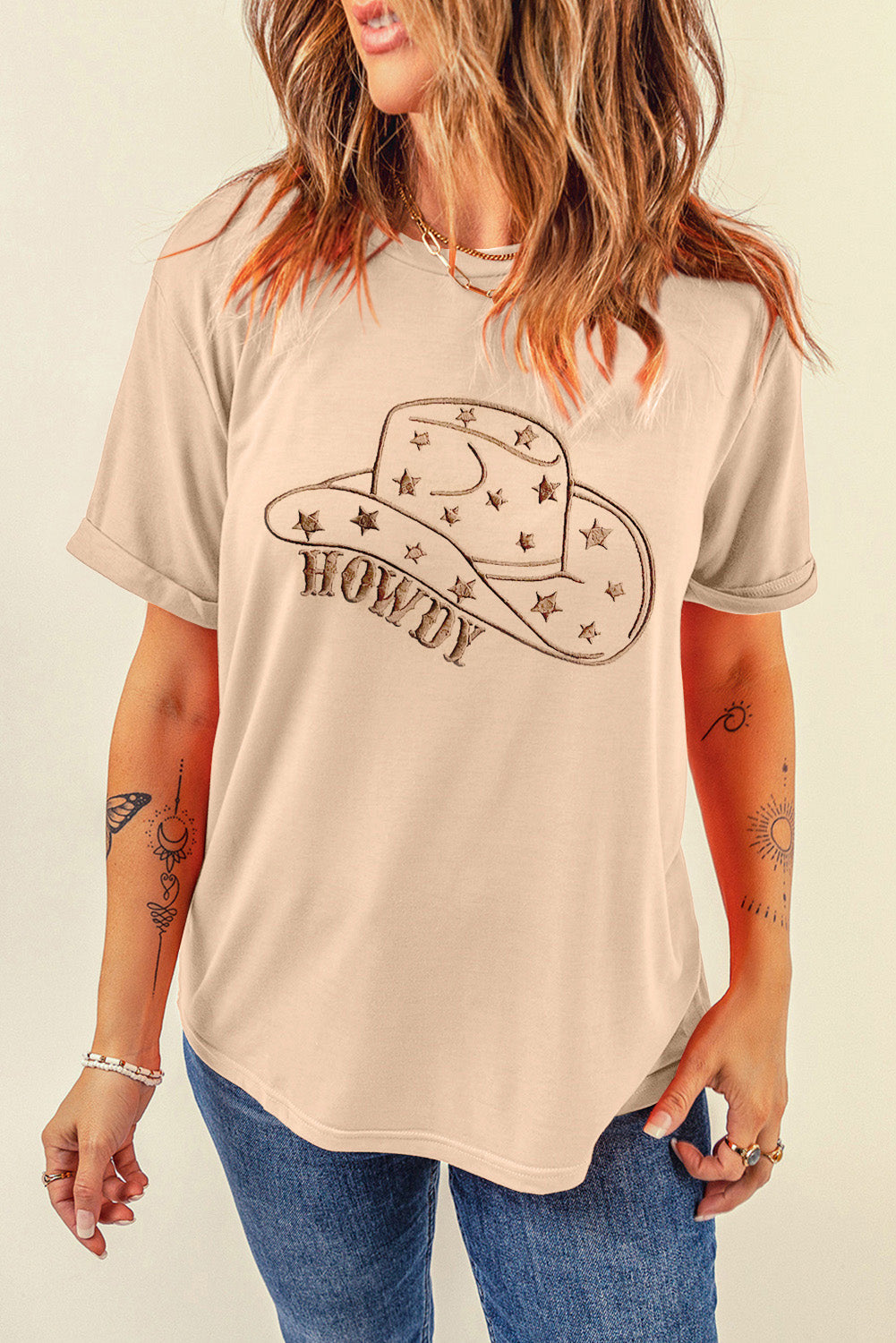 Tan graphic tee with a cowboy hat and Howdy text, short sleeves, crew neck.