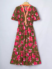 Print split neck dress with short puff sleeves, elastic waist, and tiered hem.