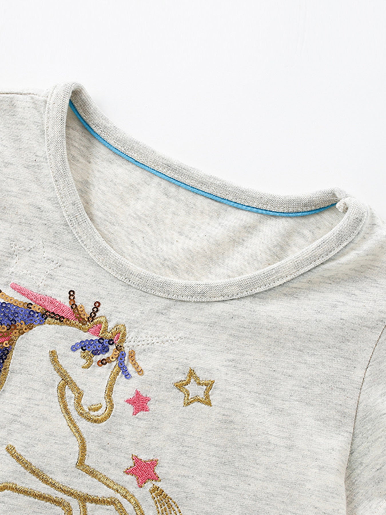 Toddler grey cotton dress with unicorn sequin embroidery and star details.