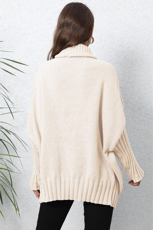 Beige ribbed turtleneck sweater with batwing sleeves and a relaxed fit.