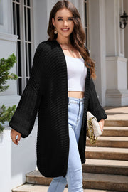 Black textured knit cocoon cardigan with balloon sleeves and open front.
